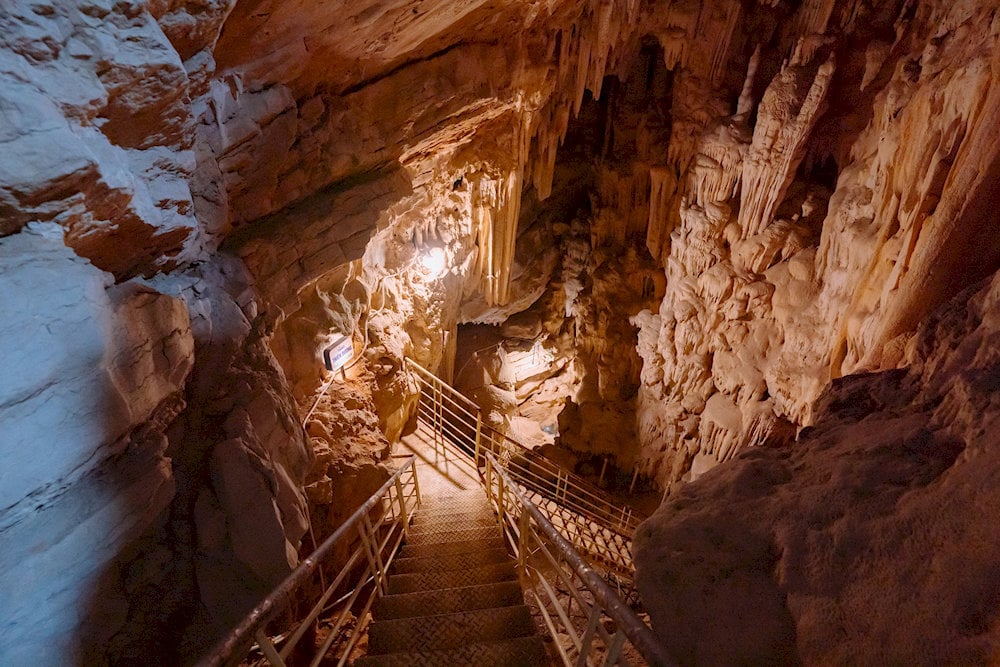 The winding stone steps lead to the cave entrance, unveiling a mystical realm where heaven and earth meet